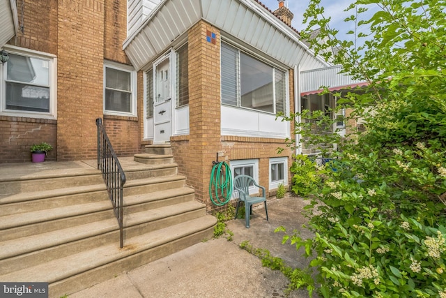 1004 N 67th St, Philadelphia, PA 19151 - view of exterior entry featuring brick siding and a chimney