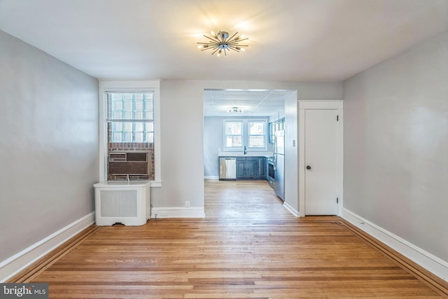 1004 N 67th St, Philadelphia, PA 19151 - unfurnished dining area featuring light wood finished floors, baseboards, and radiator heating unit