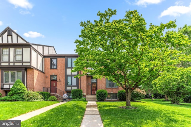31 Tudor Ct, Lutherville Timonium, MD 21093 - view of front facade with a front yard, brick siding, and stucco siding