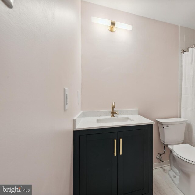 6 Roland Mews Unit R46, Baltimore, MD 21210 - bathroom featuring vanity, toilet, baseboards, a shower with shower curtain, and tile patterned flooring