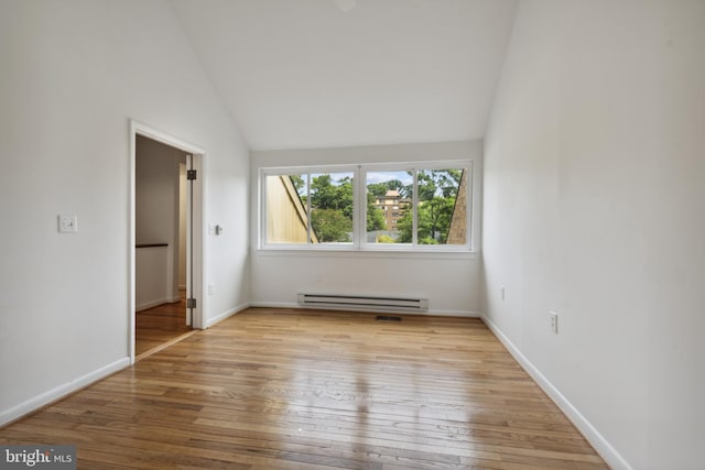6 Roland Mews Unit R46, Baltimore, MD 21210 - empty room with a baseboard heating unit, vaulted ceiling, hardwood / wood-style flooring, and baseboards