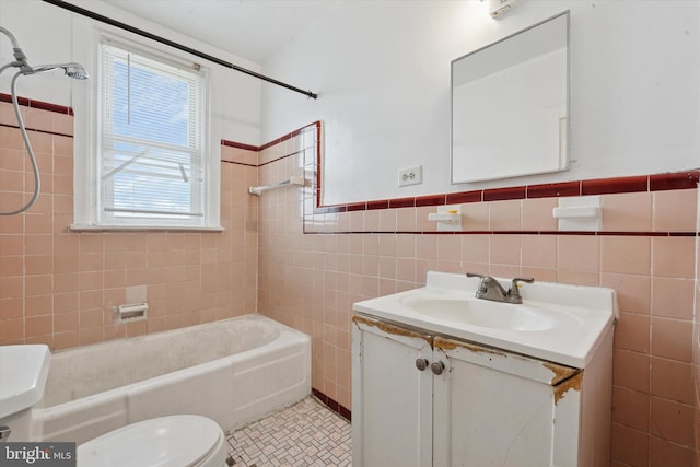 1500 Benner St, Philadelphia, PA 19149 - bathroom featuring toilet, tile walls, vanity, tub / shower combination, and a wainscoted wall