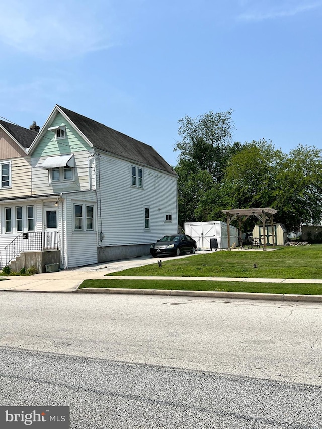 234 Erickson Ave Unit 28-31, Essington, PA 19029 - view of side of home featuring a yard and a storage unit