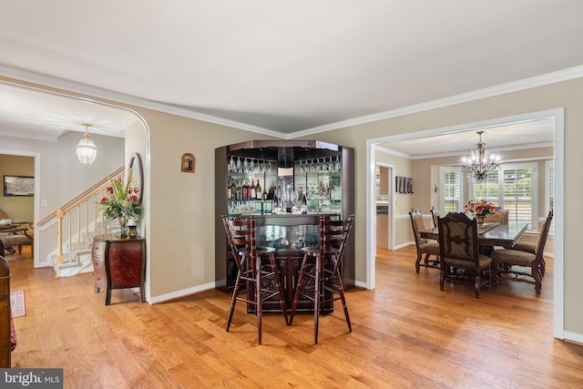 175 Mt Hope Church Rd, Stafford, VA 22554 - dining area featuring wood finished floors, stairs, ornamental molding, a dry bar, and arched walkways