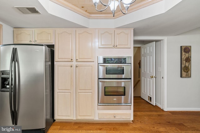 175 Mt Hope Church Rd, Stafford, VA 22554 - kitchen with stainless steel appliances, a chandelier, light wood-style flooring, a raised ceiling, and cream cabinets
