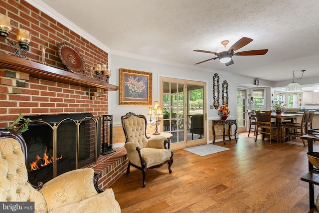 175 Mt Hope Church Rd, Stafford, VA 22554 - living room featuring wood finished floors, a fireplace, a textured ceiling, ceiling fan, and ornamental molding