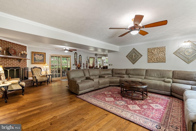 175 Mt Hope Church Rd, Stafford, VA 22554 - living area featuring a textured ceiling, wood finished floors, a ceiling fan, a fireplace, and ornamental molding
