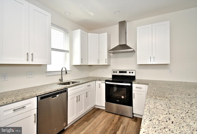 287 Yards Ct, Hatboro, PA 19040 - kitchen featuring stainless steel appliances, wall chimney exhaust hood, a sink, white cabinetry, and light stone counters
