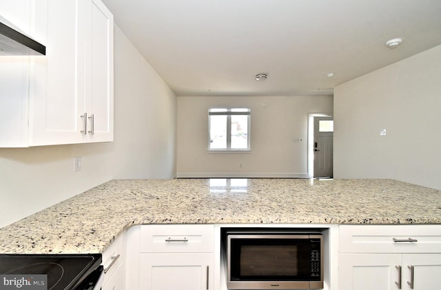 287 Yards Ct, Hatboro, PA 19040 - kitchen with black appliances, a peninsula, white cabinetry, and light stone counters