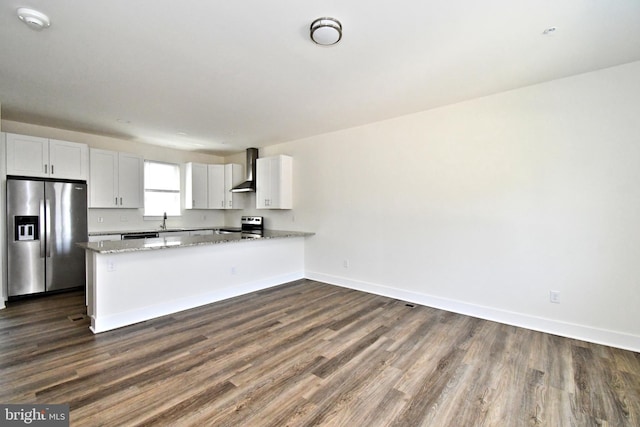 287 Yards Ct, Hatboro, PA 19040 - kitchen with stainless steel appliances, a peninsula, dark wood-type flooring, wall chimney exhaust hood, and light stone countertops