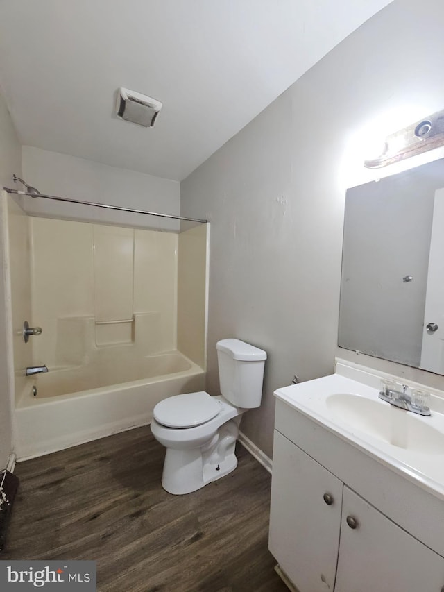 239 Grove St, Bridgeton, NJ 08302 - full bath featuring vanity, wood finished floors, toilet, shower / bath combination, and baseboards