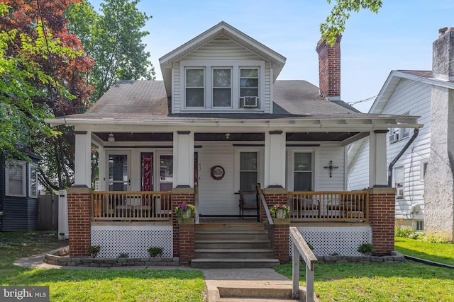 42 Lupton Ave, Woodbury, NJ 08096 - bungalow-style home with a porch, a front yard, a chimney, and a shingled roof
