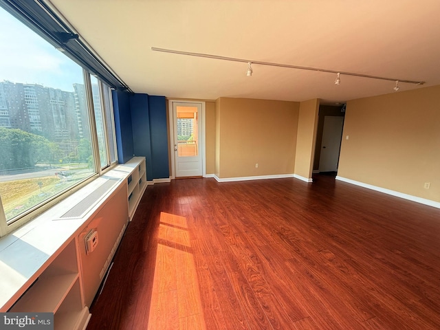 1111 Arlington Blvd Unit 907, Arlington, VA 22209 - empty room featuring rail lighting, dark wood-style flooring, and healthy amount of natural light