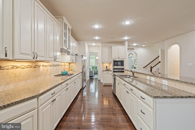 3750 Christopher Day Rd, Doylestown, PA 18902 - kitchen featuring appliances with stainless steel finishes, tasteful backsplash, white cabinets, arched walkways, and recessed lighting