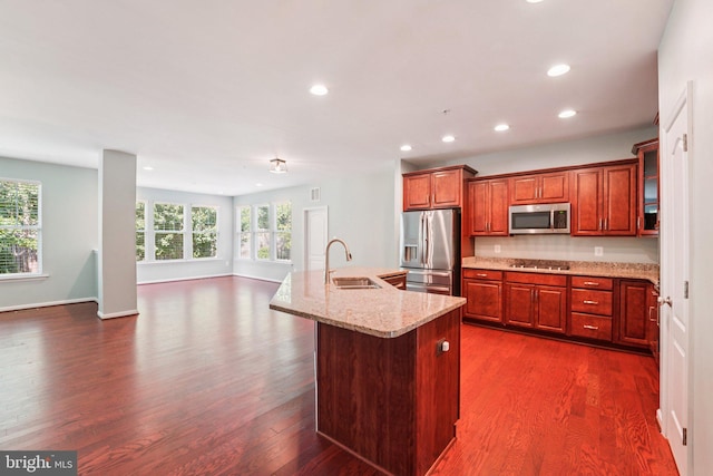 7912 Meridian Dr, Pasadena, MD 21122 - kitchen featuring stainless steel appliances, dark wood-type flooring, recessed lighting, light stone countertops, and a center island with sink