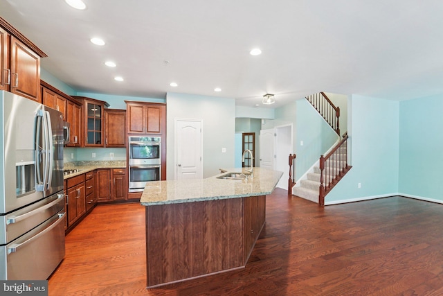 7912 Meridian Dr, Pasadena, MD 21122 - kitchen featuring stainless steel appliances, dark wood-type flooring, light stone countertops, recessed lighting, and glass insert cabinets