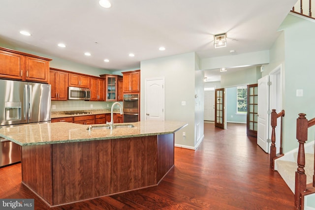 7912 Meridian Dr, Pasadena, MD 21122 - kitchen with stainless steel appliances, brown cabinets, dark wood-style flooring, light stone counters, and recessed lighting