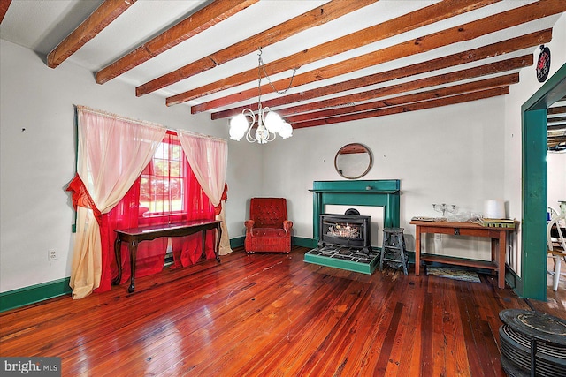 13220 Bank St, Bishopville, MD 21813 - living room featuring a wood stove, beam ceiling, hardwood / wood-style flooring, baseboards, and a chandelier