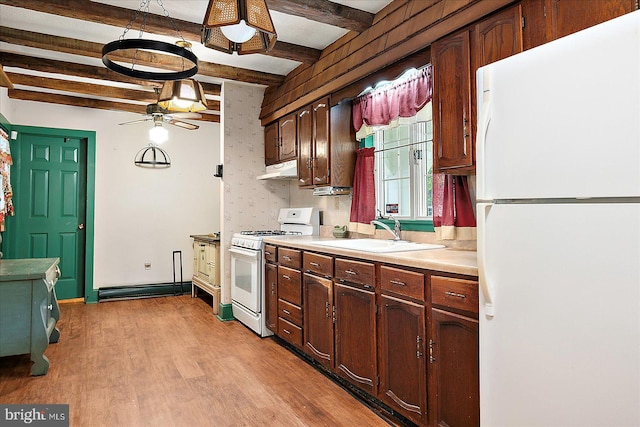 13220 Bank St, Bishopville, MD 21813 - kitchen with white appliances, a sink, under cabinet range hood, light countertops, and light wood-style floors