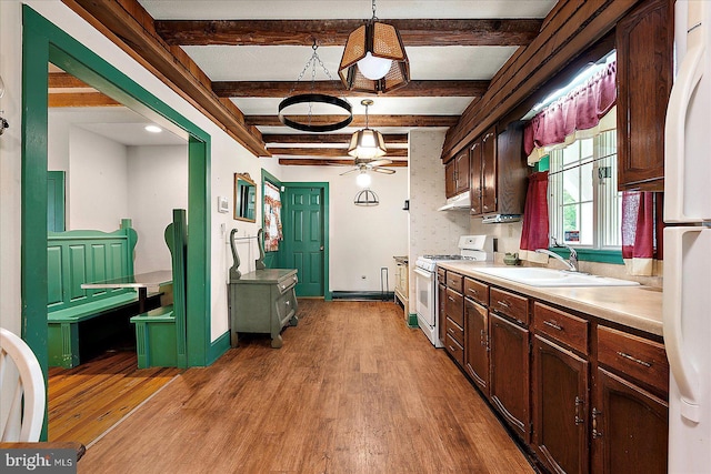 13220 Bank St, Bishopville, MD 21813 - kitchen featuring white appliances, a sink, light wood finished floors, light countertops, and beamed ceiling