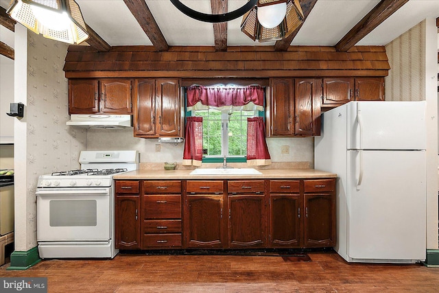 13220 Bank St, Bishopville, MD 21813 - kitchen featuring white appliances, a sink, under cabinet range hood, beamed ceiling, and light countertops
