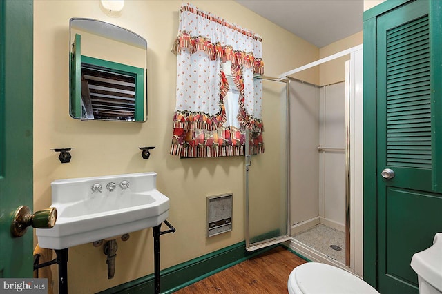 13220 Bank St, Bishopville, MD 21813 - full bathroom with toilet, a shower stall, wood finished floors, and heating unit