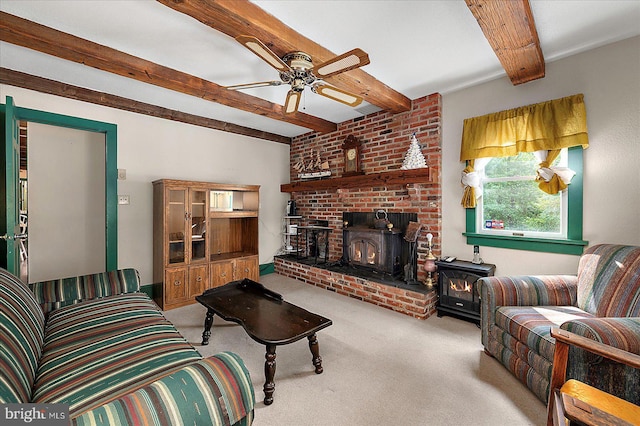 13220 Bank St, Bishopville, MD 21813 - carpeted living area featuring a wood stove, beamed ceiling, and ceiling fan