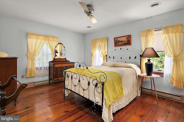 13220 Bank St, Bishopville, MD 21813 - bedroom with a baseboard radiator, multiple windows, and hardwood / wood-style floors
