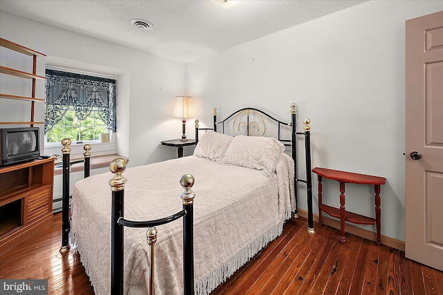 13220 Bank St, Bishopville, MD 21813 - bedroom featuring hardwood / wood-style floors, baseboards, and a textured ceiling