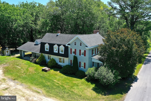 13220 Bank St, Bishopville, MD 21813 - view of front of property with a chimney, a front lawn, an attached carport, a shingled roof, and driveway