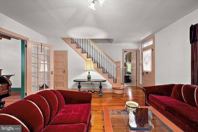 13220 Bank St, Bishopville, MD 21813 - living room featuring stairway, wood finished floors, and a textured ceiling