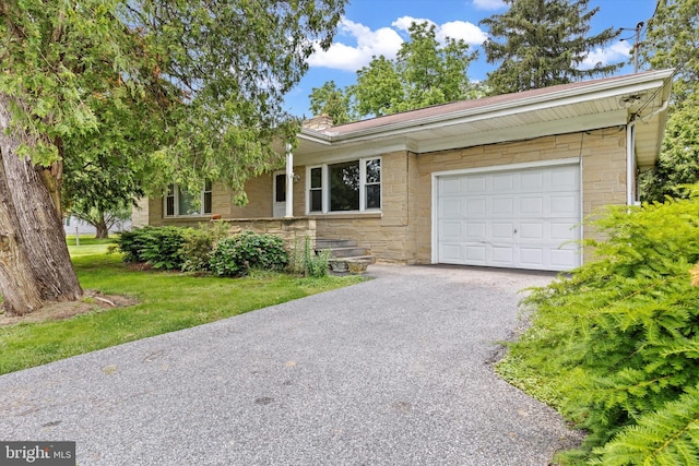 3415 E Market St, York, PA 17402 - ranch-style home featuring stone siding, asphalt driveway, an attached garage, and a front yard