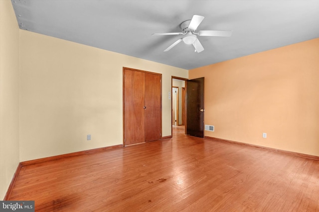 3415 E Market St, York, PA 17402 - unfurnished bedroom with light wood-style floors, baseboards, a closet, and a ceiling fan