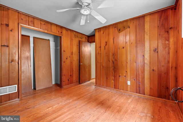 3415 E Market St, York, PA 17402 - spare room with wood finished floors, ceiling fan, and wooden walls