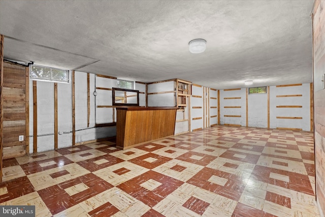 3415 E Market St, York, PA 17402 - basement featuring tile patterned floors, healthy amount of natural light, and a textured ceiling