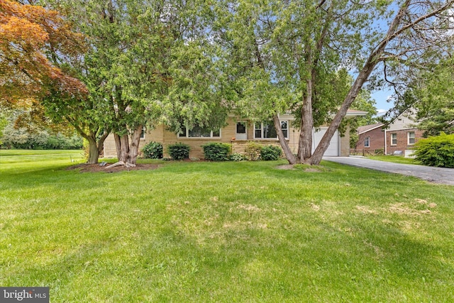3415 E Market St, York, PA 17402 - obstructed view of property featuring driveway, a garage, and a front yard