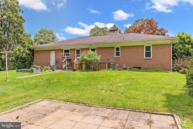 3415 E Market St, York, PA 17402 - rear view of house featuring a lawn, a chimney, and brick siding