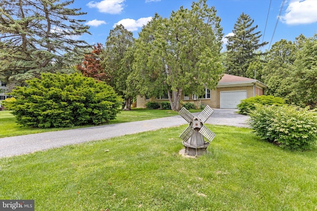 3415 E Market St, York, PA 17402 - view of property hidden behind natural elements with a garage, a front lawn, and driveway