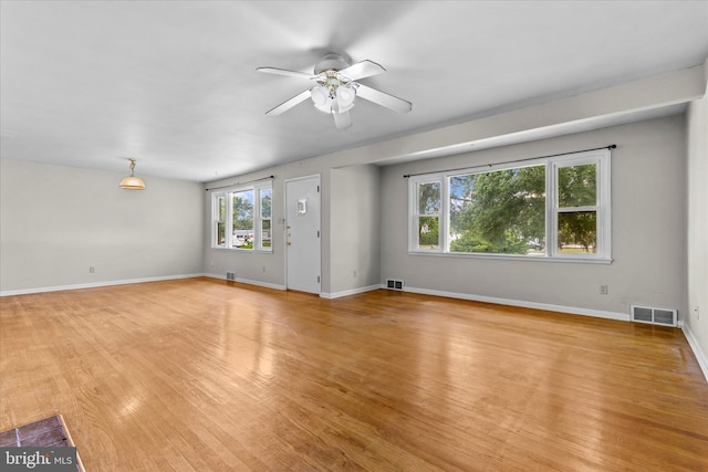 3415 E Market St, York, PA 17402 - unfurnished living room featuring ceiling fan, light wood finished floors, and baseboards
