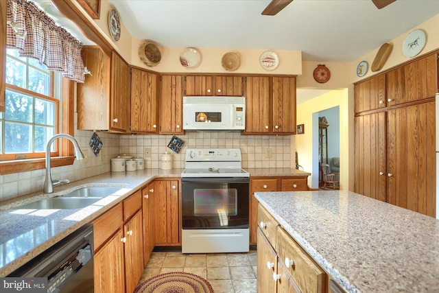 74 Acker Rd, Newport, PA 17074 - kitchen featuring white appliances, a sink, brown cabinetry, and tasteful backsplash