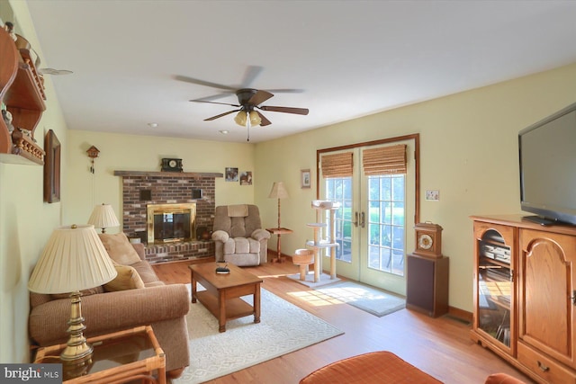 74 Acker Rd, Newport, PA 17074 - living area with light wood finished floors, a ceiling fan, french doors, and a fireplace