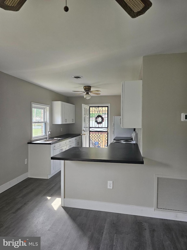 36652 Woodbush Dr, Bushwood, MD 20618 - kitchen featuring dark countertops, dark wood-type flooring, a ceiling fan, white cabinetry, and a peninsula