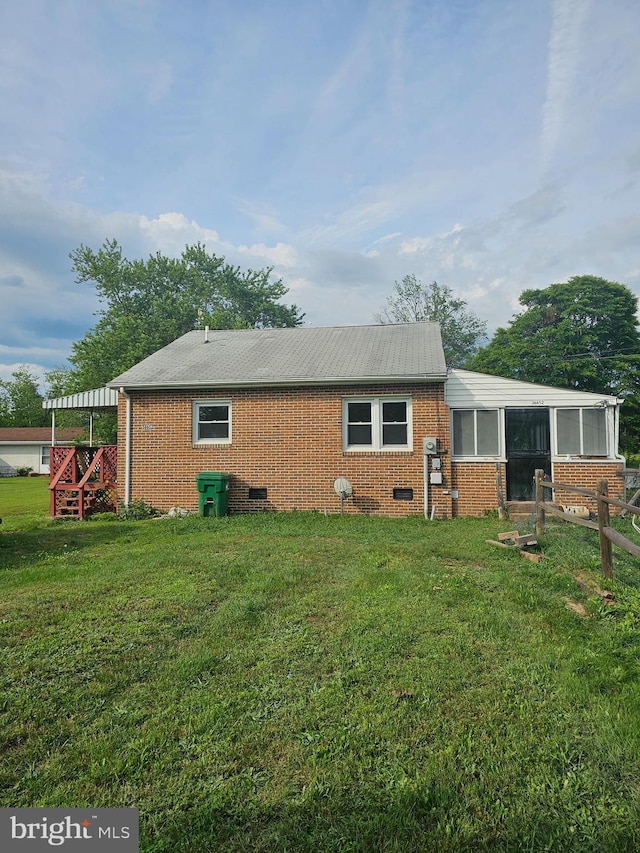 36652 Woodbush Dr, Bushwood, MD 20618 - back of house featuring brick siding, a sunroom, and a lawn