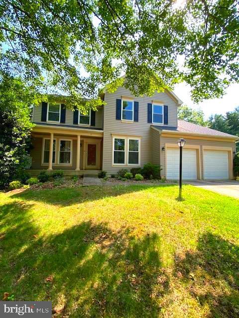 2 Raindrop Cir, Reisterstown, MD 21136 - traditional-style house featuring driveway, a front lawn, a garage, and a porch