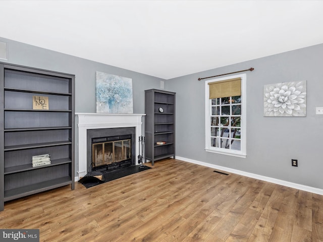 6848 Whistling Swan Way, New Market, MD 21774 - unfurnished living room featuring a fireplace with flush hearth and wood finished floors