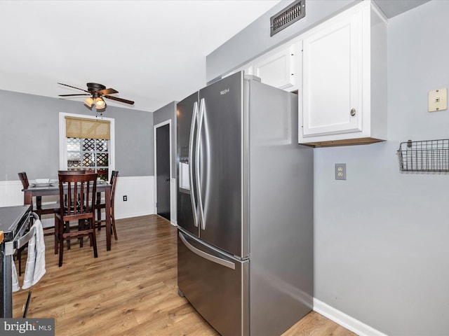 6848 Whistling Swan Way, New Market, MD 21774 - kitchen with stainless steel fridge with ice dispenser, range with electric stovetop, a ceiling fan, white cabinets, and light wood-style floors