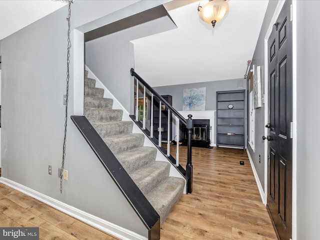 6848 Whistling Swan Way, New Market, MD 21774 - foyer entrance with a fireplace with flush hearth, stairway, and light wood-style flooring