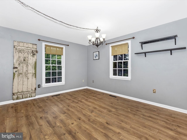 6848 Whistling Swan Way, New Market, MD 21774 - unfurnished room with a chandelier and wood finished floors