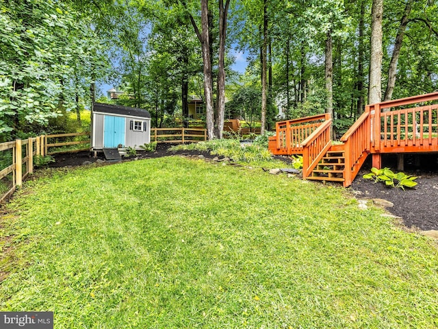 6848 Whistling Swan Way, New Market, MD 21774 - fenced backyard featuring a wooden deck, a storage unit, and view of wooded area