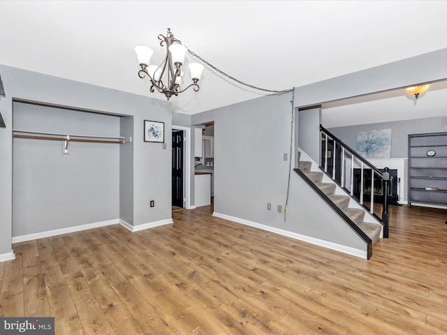 6848 Whistling Swan Way, New Market, MD 21774 - unfurnished living room with wood finished floors, a chandelier, and stairs